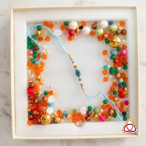The Celestial Sea Treasure Rakhi and Bead Keepsake Set