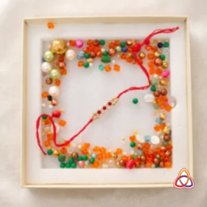 Kundan-Inspired Red-White Gem Rakhi in a Festive Bead Box