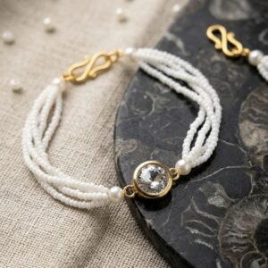 Elegant Multi Strand Bracelet Resting On A Dark Stone Surface
